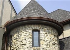 round addition on home with cone shaped roof
